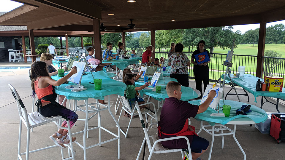 Father and child high-fiving on the golf course