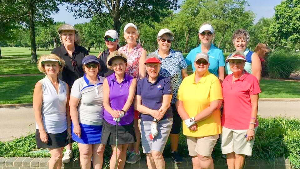 Father and child high-fiving on the golf course