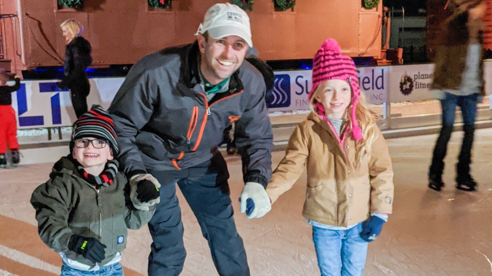 Father and child high-fiving on the golf course