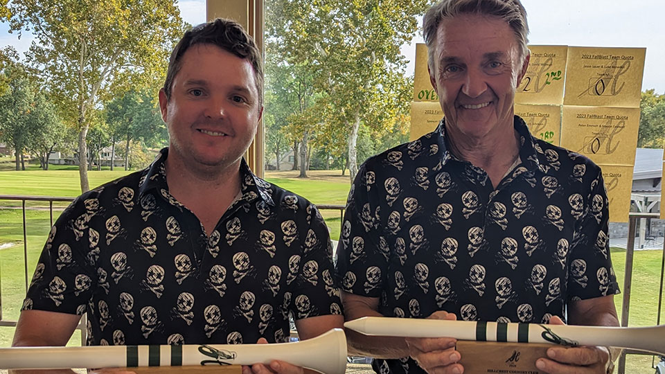 Father and child high-fiving on the golf course