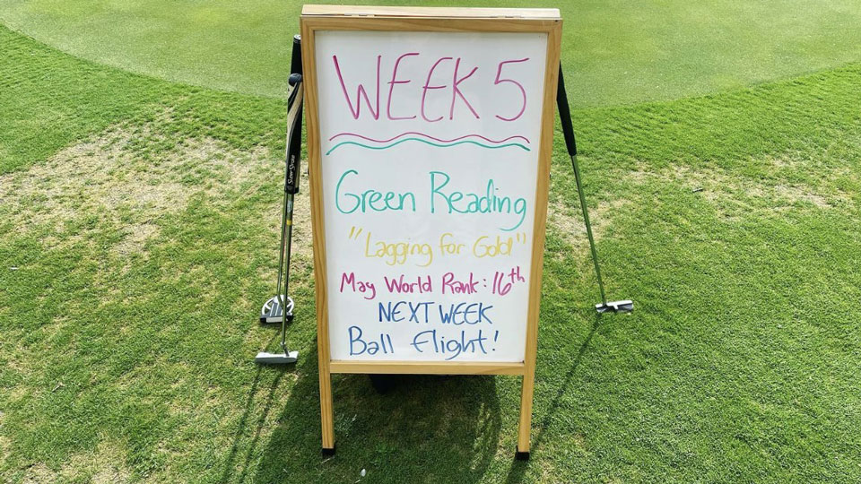 Father and child high-fiving on the golf course